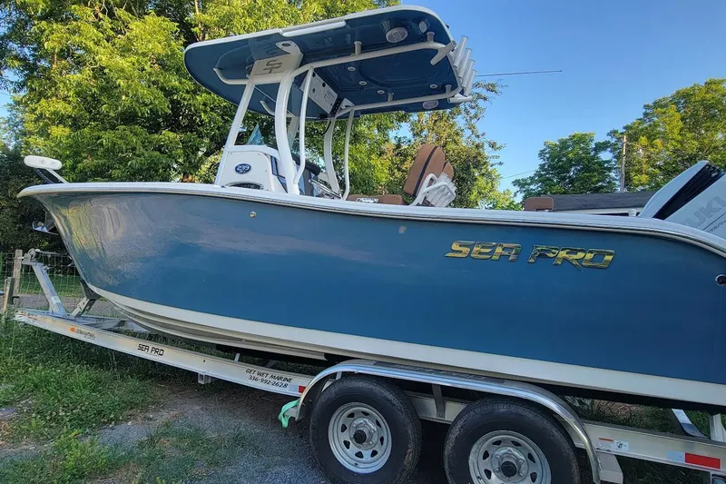 Slide: The Image of 2023 Sea Pro 239 Deep V CC boat on trailer, side view, outdoors. - 1