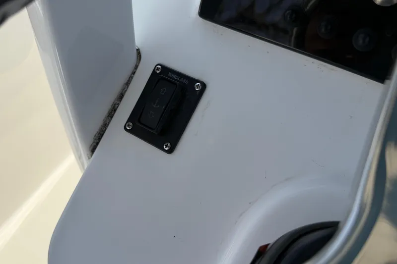 Slide: The Image of 2023 Sea Pro 239 Deep V CC windlass control switch on boat console. - 11