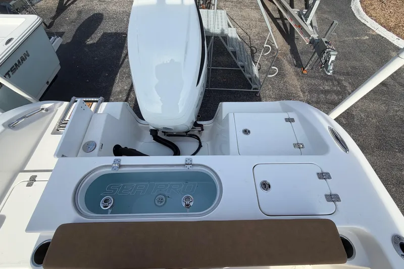 Slide: The Image of 2023 Sea Pro 239 Deep V CC boat with outboard motor and storage compartments. - 16