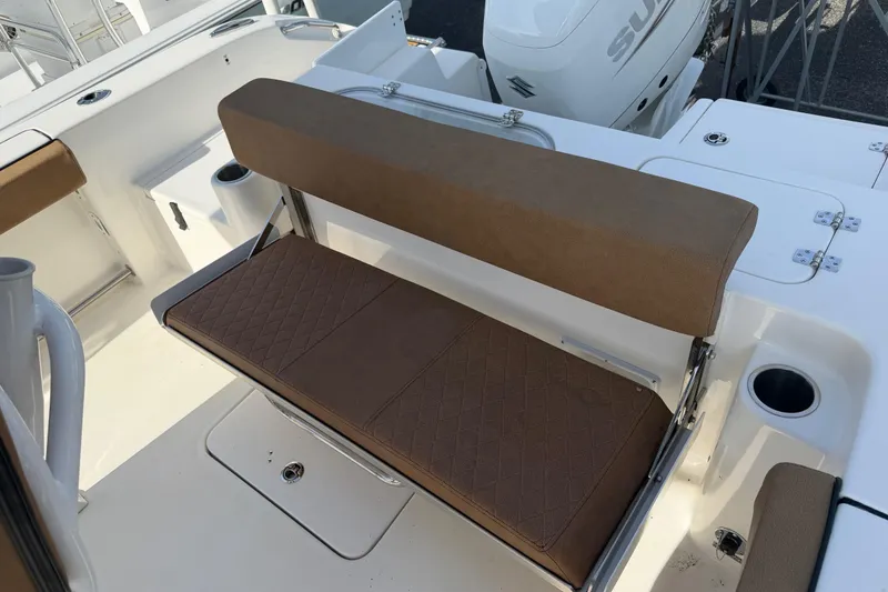 Slide: The Image of 2023 Sea Pro 239 Deep V CC boat with brown cushioned seating and cup holders. - 19