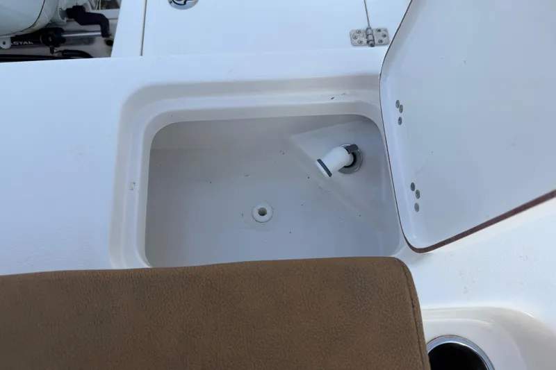 Slide: The Image of 2023 Sea Pro 239 Deep V CC boat compartment with open lid and drain. - 20