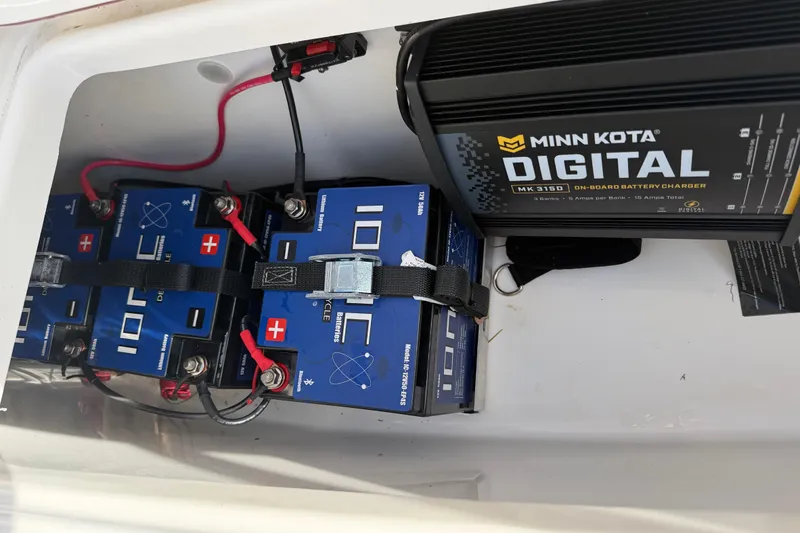 Slide: The Image of Battery compartment of 2023 Sea Pro 239 Deep V CC with Minn Kota charger. - 23