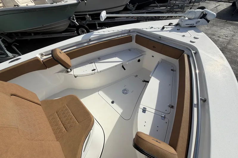 Slide: The Image of 2023 Sea Pro 239 Deep V CC boat interior with brown seating and storage compartments. - 24