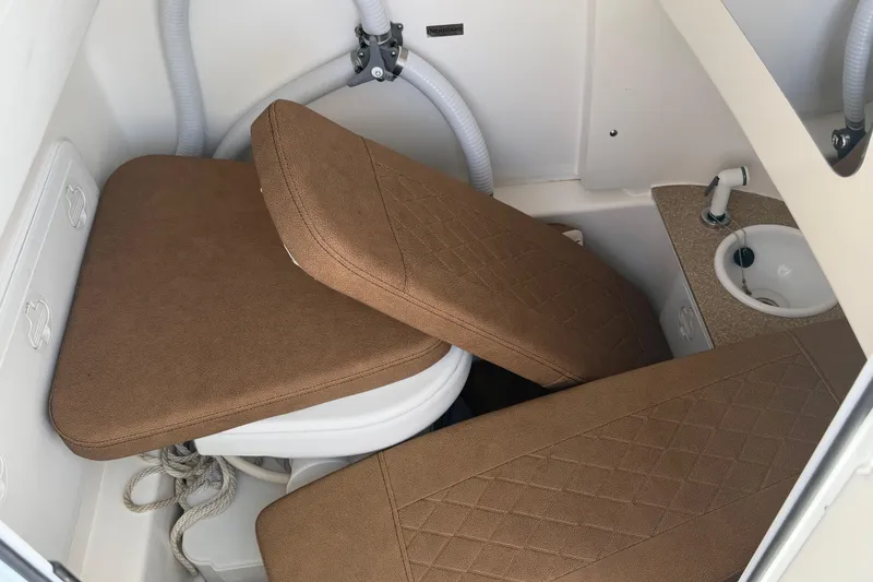 Slide: The Image of 2023 Sea Pro 239 Deep V CC interior with brown cushions and compact sink. - 25