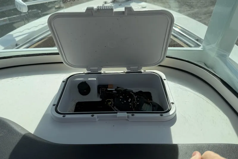 Slide: The Image of Open storage compartment on 2023 Sea Pro 239 Deep V CC boat dashboard. - 26