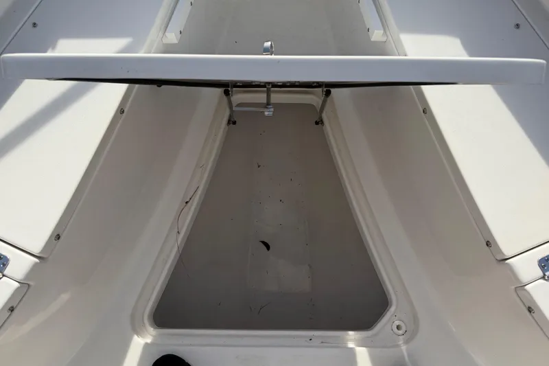 Slide: The Image of 2023 Sea Pro 239 Deep V CC boat storage compartment, open and empty. - 27