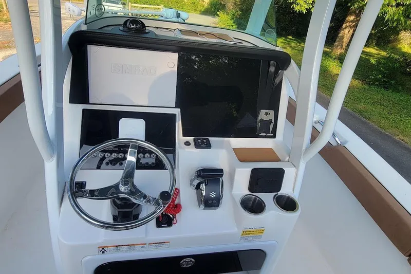 Slide: The Image of 2023 Sea Pro 239 Deep V CC boat console with steering wheel and controls. - 3