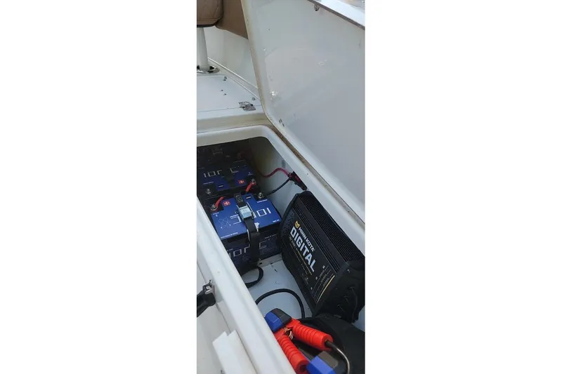 Slide: The Image of 2023 Sea Pro 239 Deep V CC boat battery compartment with digital charger. - 7
