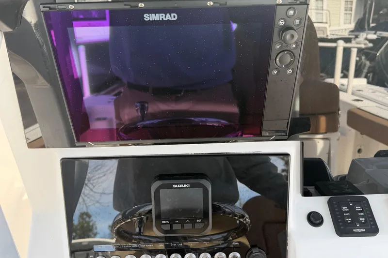 Slide: The Image of 2023 Sea Pro 239 Deep V CC dashboard with Simrad and Suzuki displays. - 9