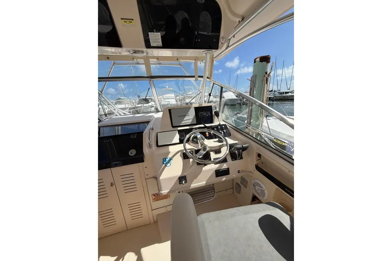 Slide: The Image of 2008 Grady-White Marlin 300 boat helm with Garmin navigation, docked at marina. - 10
