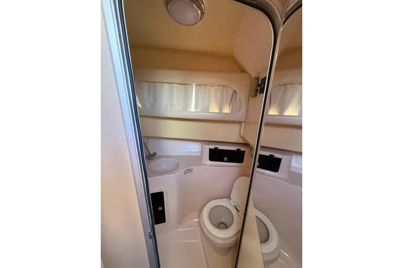 Slide: The Image of 2008 Grady-White Marlin 300 boat bathroom with toilet and sink. - 13