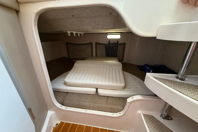 Slide: The Image of 2008 Grady-White Marlin 300 cabin interior with cushioned seating and compact design. - 14