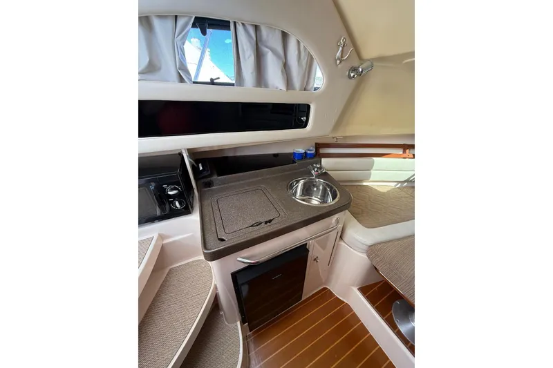 Slide: The Image of 2008 Grady-White Marlin 300 cabin interior with kitchenette and seating area. - 15