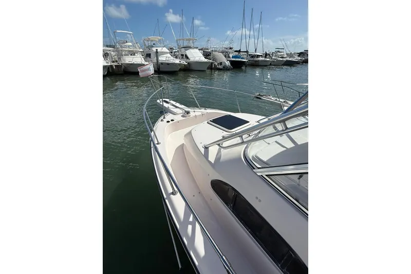 Slide: The Image of 2008 Grady-White Marlin 300 boat docked in a marina under clear skies. - 4