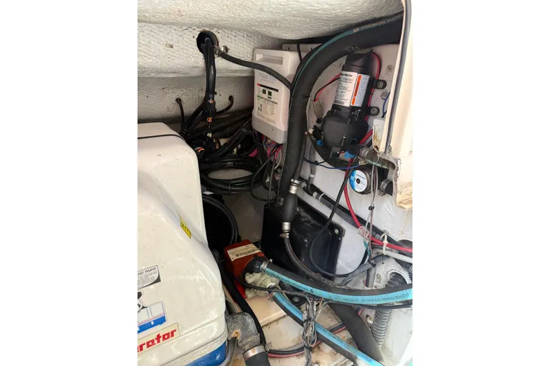 Slide: The Image of 2008 Grady-White Marlin 300 engine compartment with wiring and components. - 7