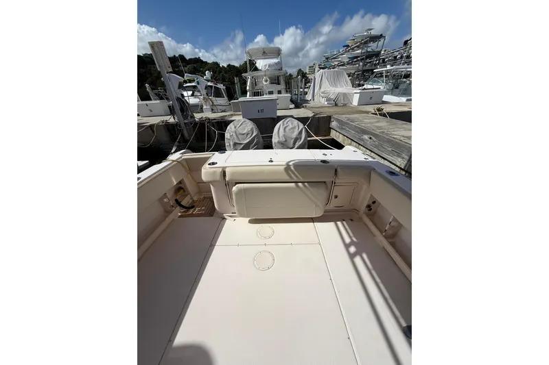 Slide: The Image of 2008 Grady-White Marlin 300 boat interior at marina, clear sky background. - 8