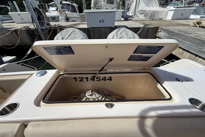 Slide: The Image of Open storage compartment on 2008 Grady-White Marlin 300 boat, containing coiled rope. - 9