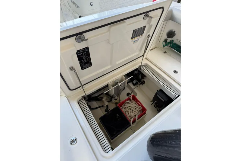 Slide: The Image of 2016 Boston Whaler 330 Outrage storage compartment with ropes and equipment. - 10