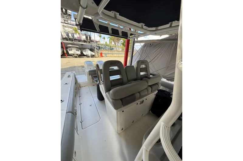 Slide: The Image of 2016 Boston Whaler 330 Outrage interior with cushioned seating and storage. - 11