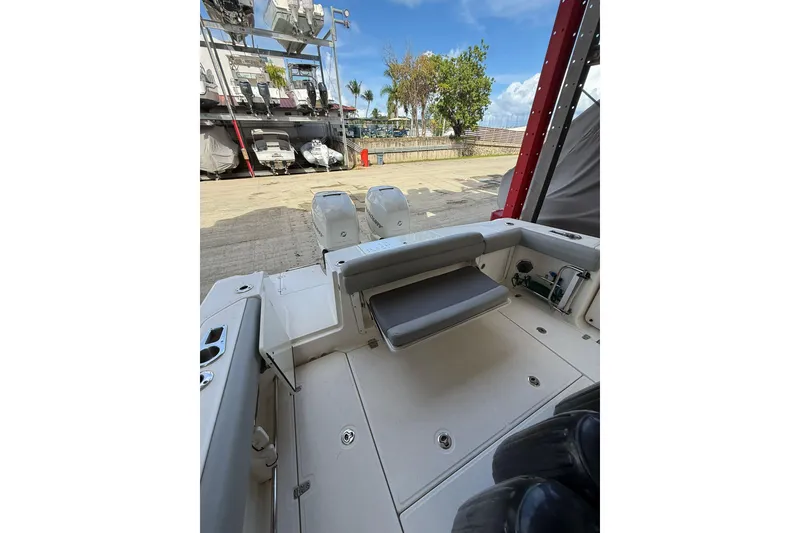 Slide: The Image of 2016 Boston Whaler 330 Outrage boat interior with seating and dual engines. - 12