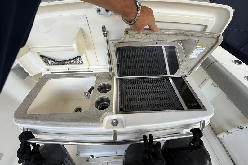 Slide: The Image of Boston Whaler 330 Outrage 2016 boat sink and grill station with storage compartment. - 6