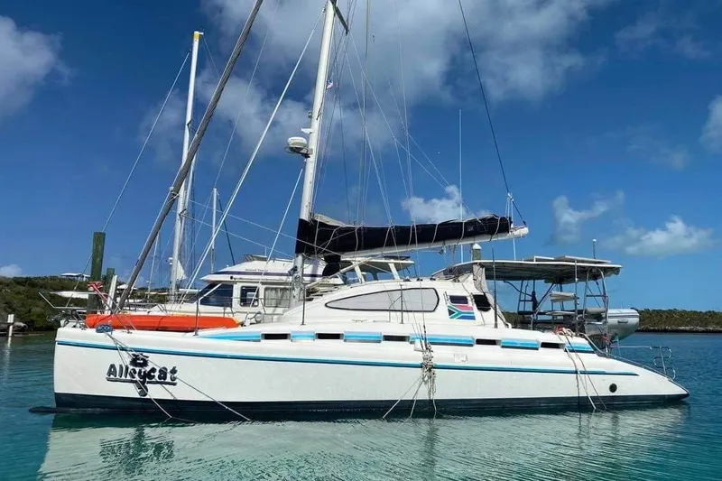 Slide: The Image of 2004 Island Spirit 400 catamaran docked in clear blue water under a sunny sky. - 1