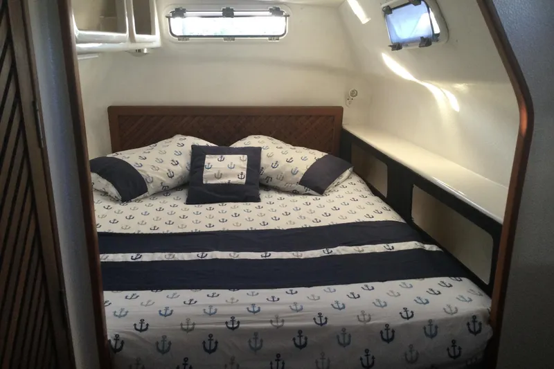 Slide: The Image of Cozy cabin bedroom in 2004 Island Spirit 400 yacht with nautical-themed bedding. - 12