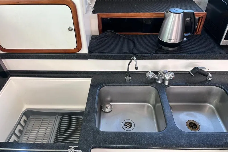 Slide: The Image of Galley kitchen of 2004 Island Spirit 400 yacht with dual sinks and electric kettle. - 14