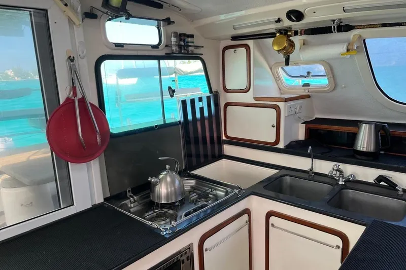 Slide: The Image of Interior of 2004 Island Spirit 400 yacht kitchen with stove, sink, and ocean view. - 17