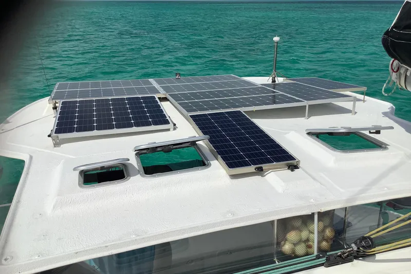 Slide: The Image of Solar panels on 2004 Island Spirit 400 catamaran, sailing in clear turquoise waters. - 2
