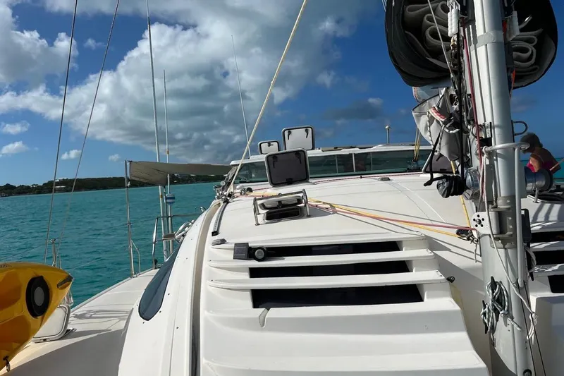 Slide: The Image of Sailing on a 2004 Island Spirit 400 catamaran in turquoise waters under a blue sky. - 21