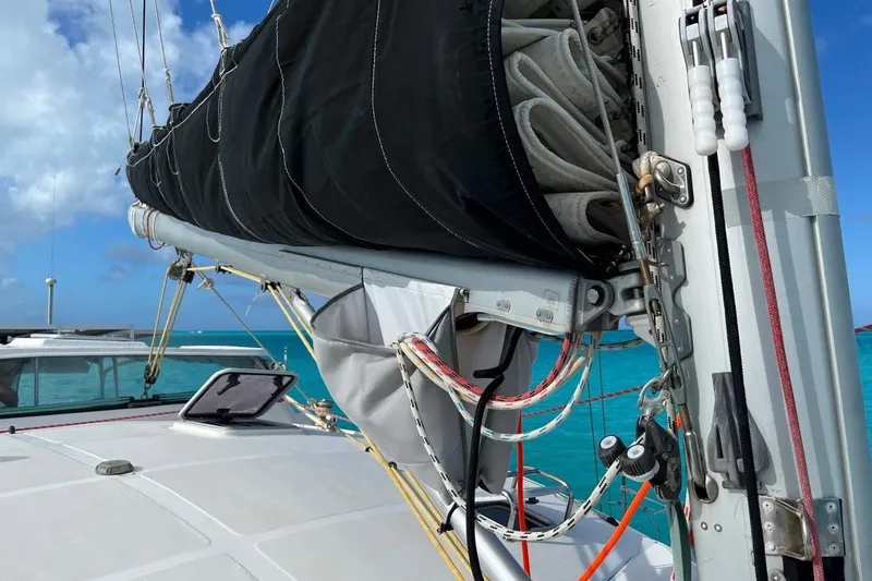 Slide: The Image of Sailboat Island Spirit 400, 2004 model, with sails furled, on turquoise water background. - 24