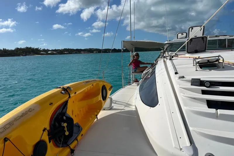 Slide: The Image of 2004 Island Spirit 400 catamaran with kayak on deck, sailing in clear blue waters. - 27