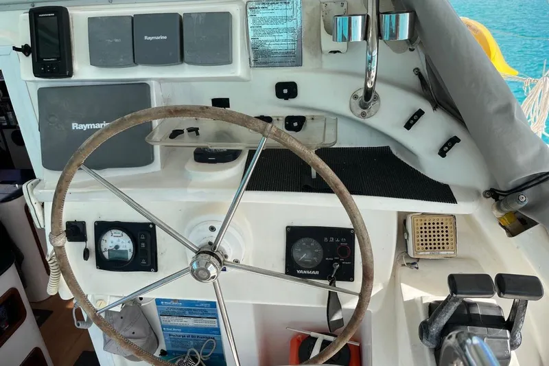 Slide: The Image of Steering wheel and controls of a 2004 Island Spirit 400 sailboat cockpit. - 29