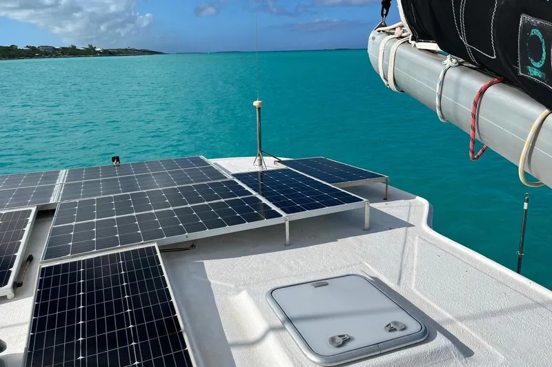 Slide: The Image of Solar panels on 2004 Island Spirit 400 catamaran, turquoise sea background. - 34