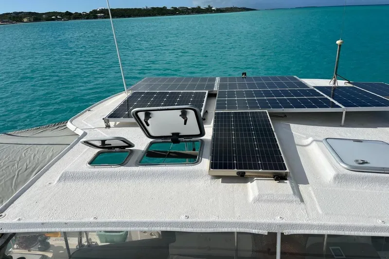 Slide: The Image of 2004 Island Spirit 400 catamaran with solar panels on turquoise water. - 35