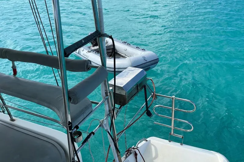 Slide: The Image of Island Spirit 400 sailboat with dinghy on turquoise water, 2004 model. - 36