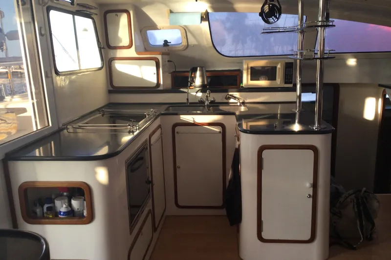 Slide: The Image of Interior of 2004 Island Spirit 400 yacht kitchen with modern amenities and sleek design. - 4