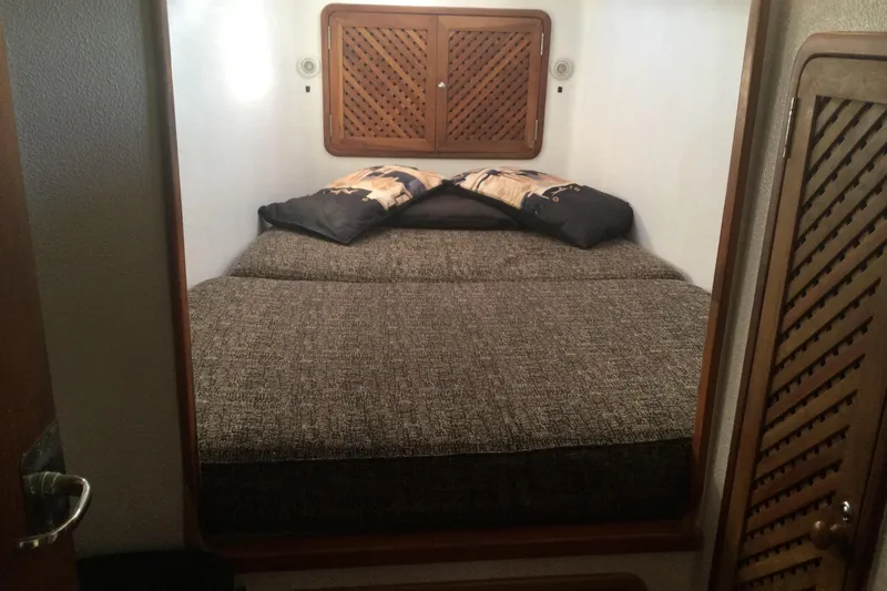 Slide: The Image of Cozy cabin bedroom in 2004 Island Spirit 400 yacht with wooden accents. - 6