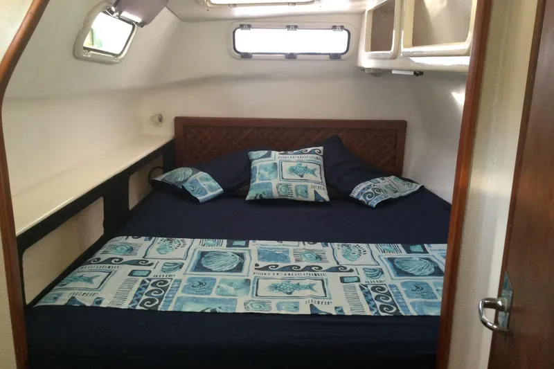 Slide: The Image of Cozy cabin bedroom in 2004 Island Spirit 400 yacht with nautical-themed bedding. - 7