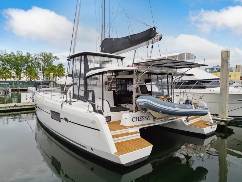Slide: The Image of 2019 Lagoon 42 catamaran docked with dinghy. - 1