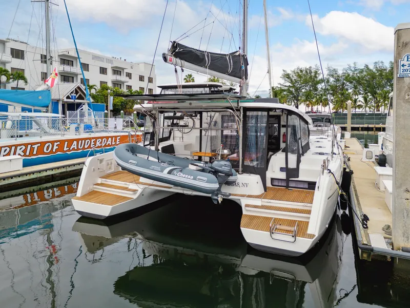 Slide: The Image of 2019 Lagoon 42 catamaran docked with dinghy. - 12