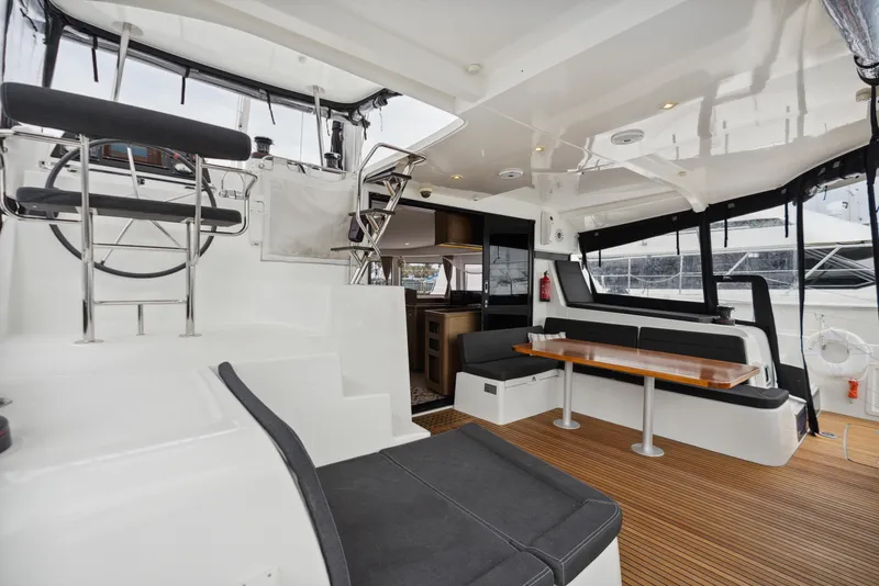 Slide: The Image of Interior of a 2019 Lagoon 42 yacht with wooden table. - 22