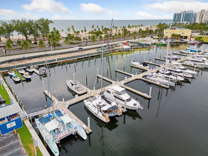 Slide: The Image of 2019 Lagoon 42 catamaran docked in marina, surrounded by boats. - 3