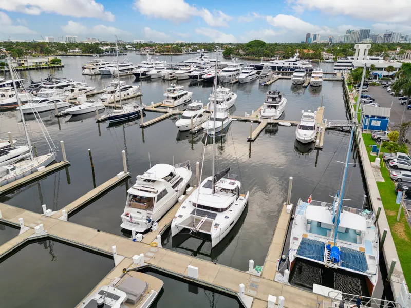 Slide: The Image of 2019 Lagoon 42 catamaran docked in marina, surrounded by boats. - 4