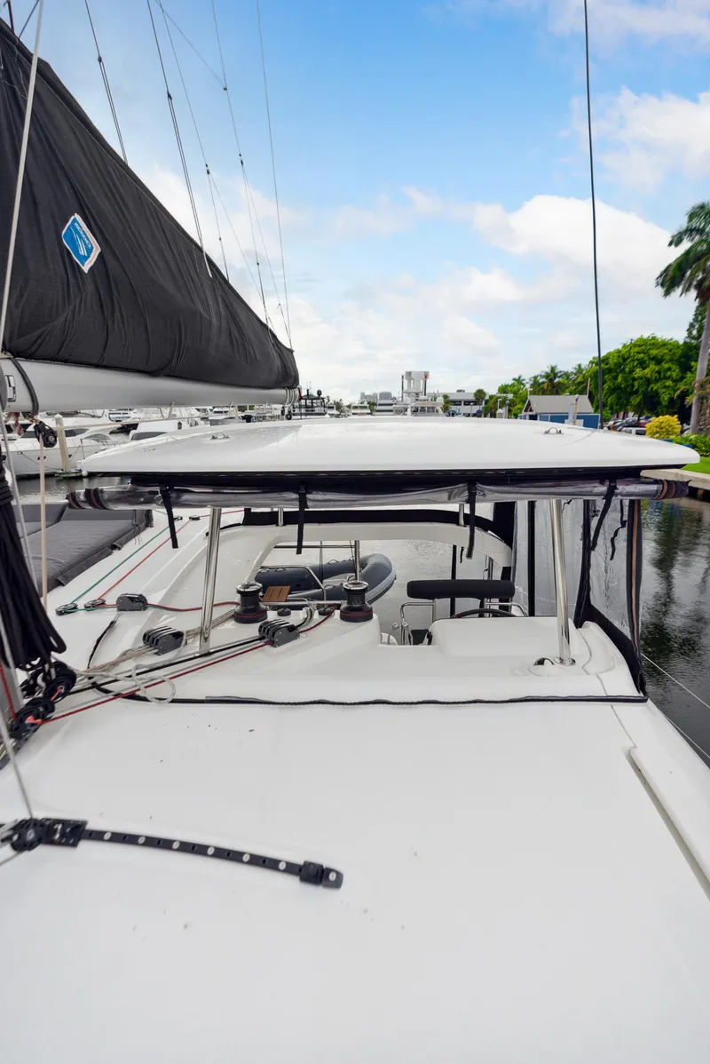Slide: The Image of 2019 Lagoon 42 catamaran docked with sail and lounging area. - 40