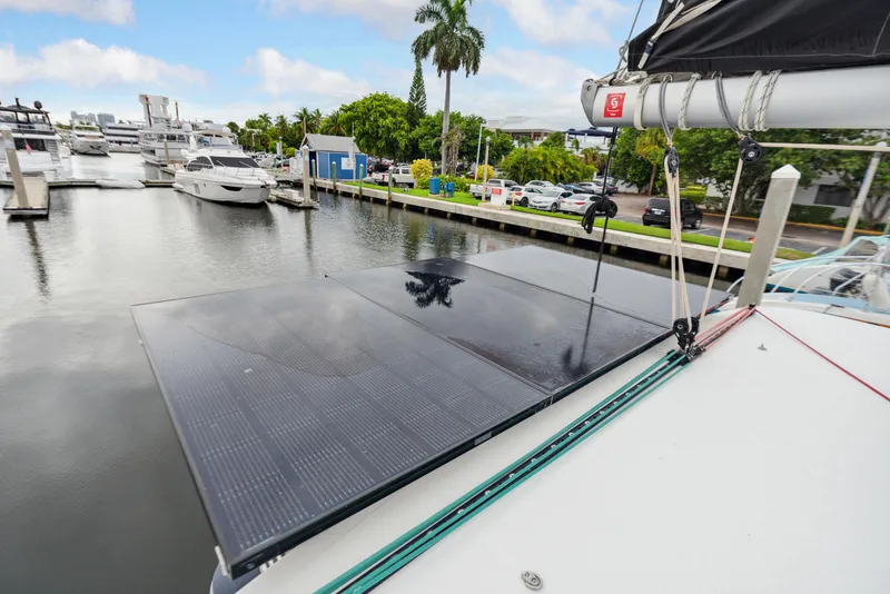 Slide: The Image of 2019 Lagoon 42 catamaran with lounging area and helm station in harbor. - 43