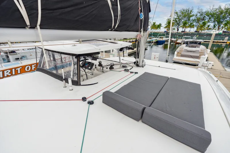 Slide: The Image of 2019 Lagoon 42 catamaran in harbor, netting and seating area visible. - 45