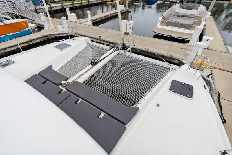 Slide: The Image of Lagoon 42 catamaran, 2019 model, docked in calm waters. - 46