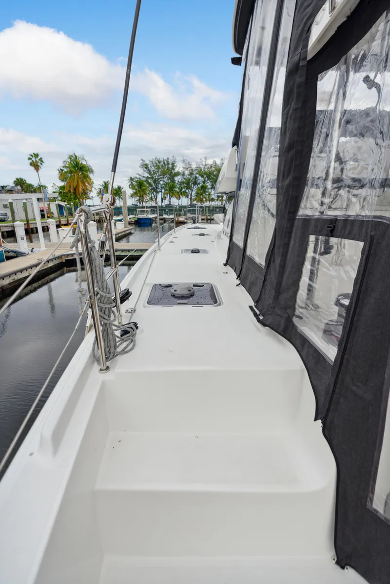 Slide: The Image of 2019 Lagoon 42 catamaran docked at marina. - 48